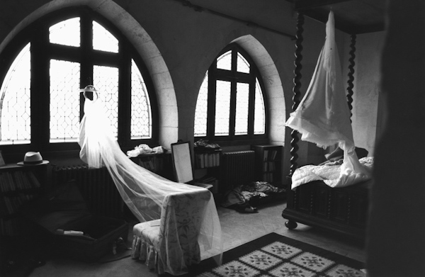 photo by New York City based wedding photographer Karen Hill - gorgeous black and white photo of full length veil hanging in window